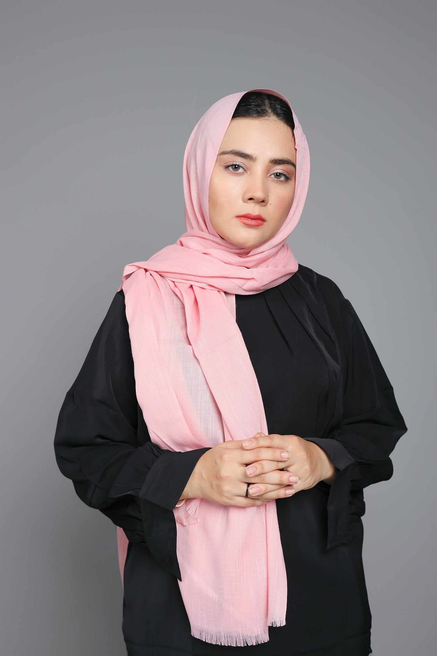 Vintage Pink Cotton Viscose Hijab folded neatly, displaying its light to medium thickness and delicate fringes.