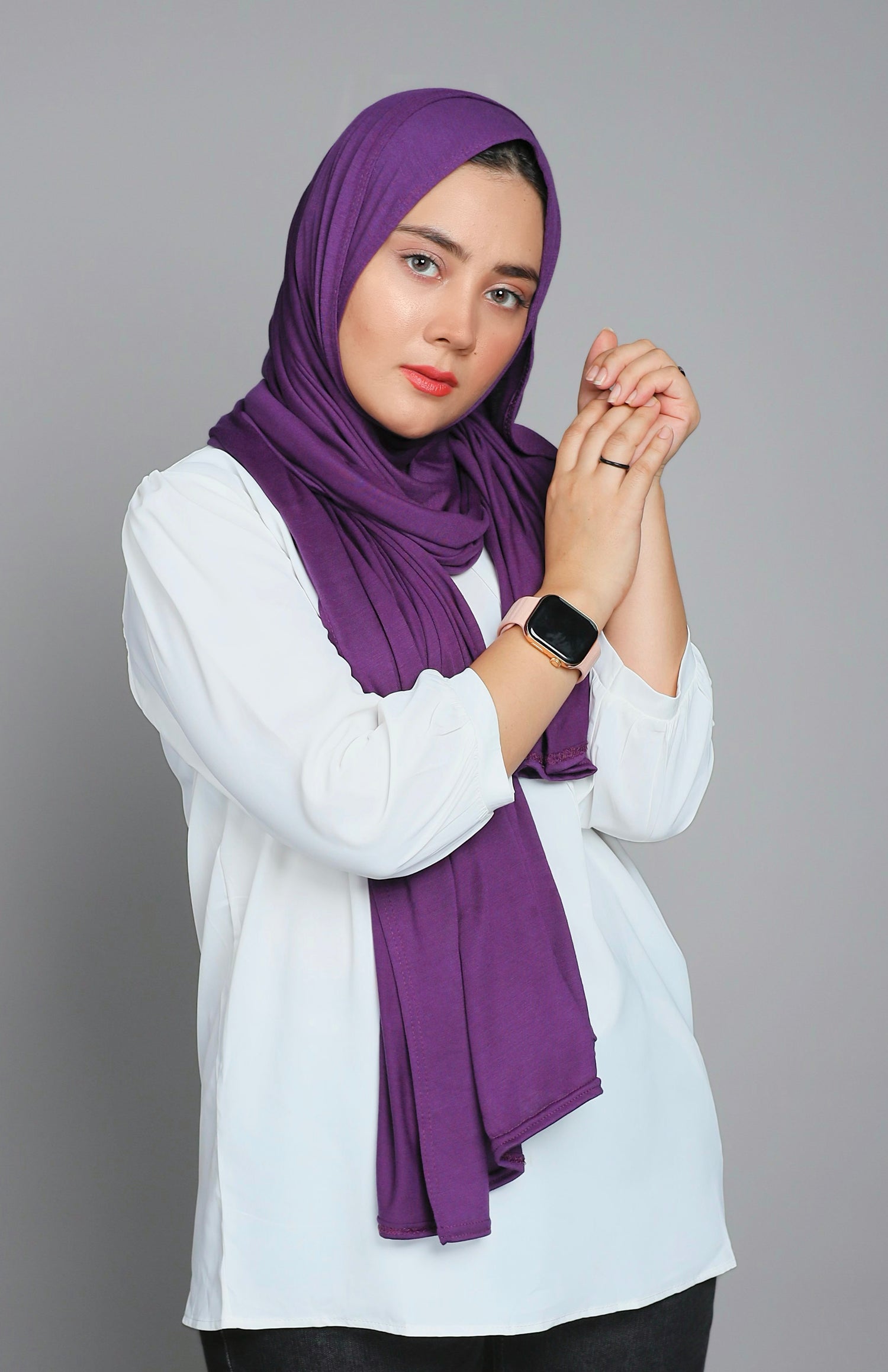 Elegant hijab queen adorned in a Violet Jersey Hijab on white top.