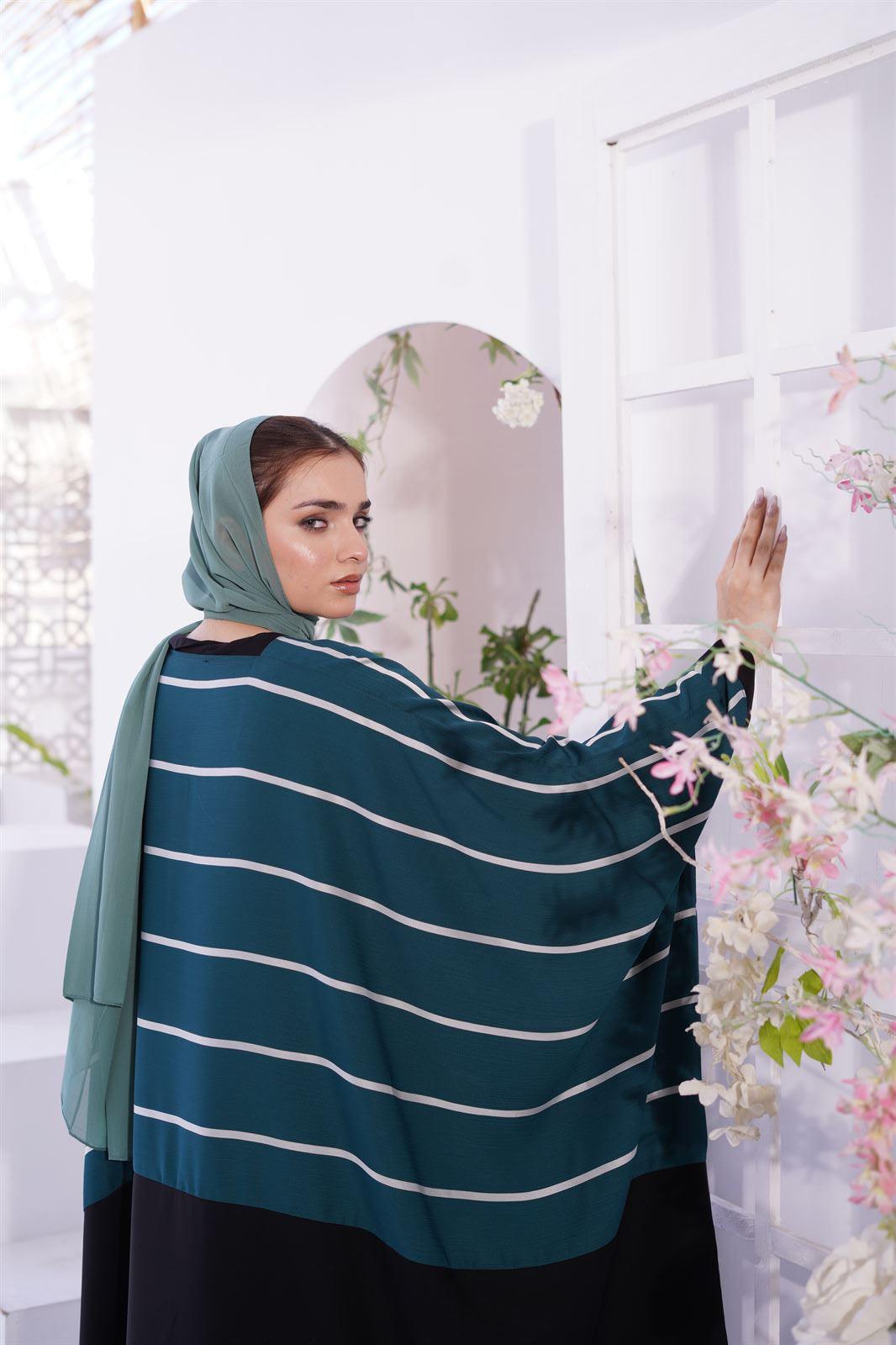 Girl looking back in a Zoom line Sage color jilbab abaya.