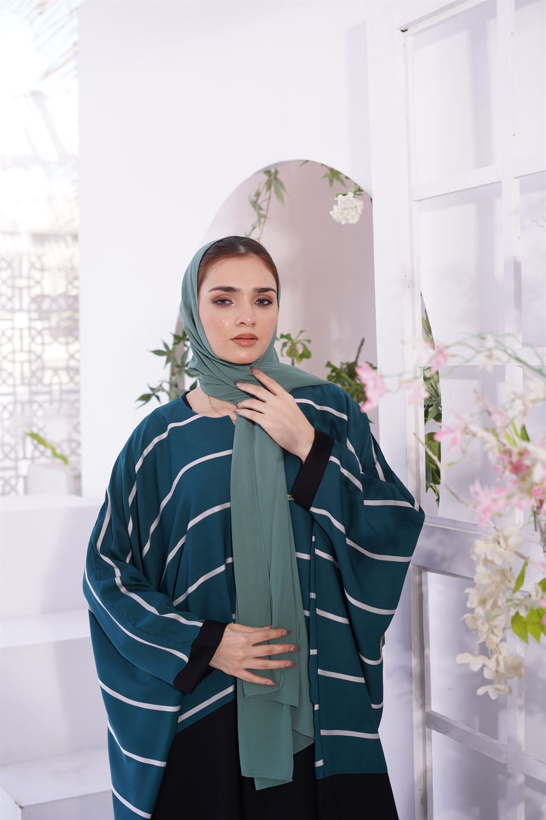 Abayas and Jilbabs. front view of a Girl wearing zoom line Jilbab in sage. 