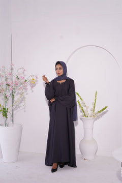 Girl wearing paintex kaftan maxi abaya in charcoal grey. front view.