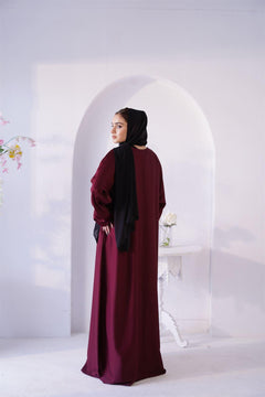 Luxury Abaya Online. Woman Wearing Amirah Abaya In maroon color. Back view.