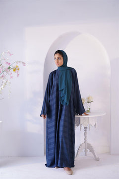 Girl wearing Zoom emboss Gown Abaya in Peacock shade. Fornt view.