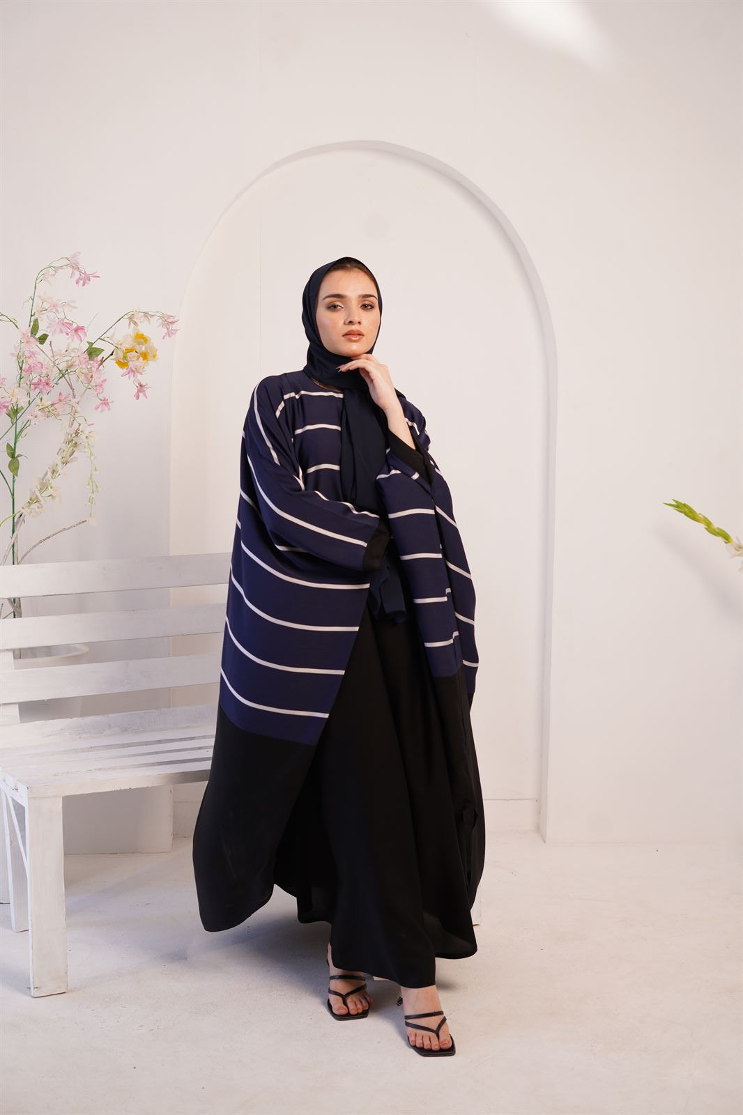 Woman wearing navy blue Zoom line ladies jilbab abaya. Looking front.