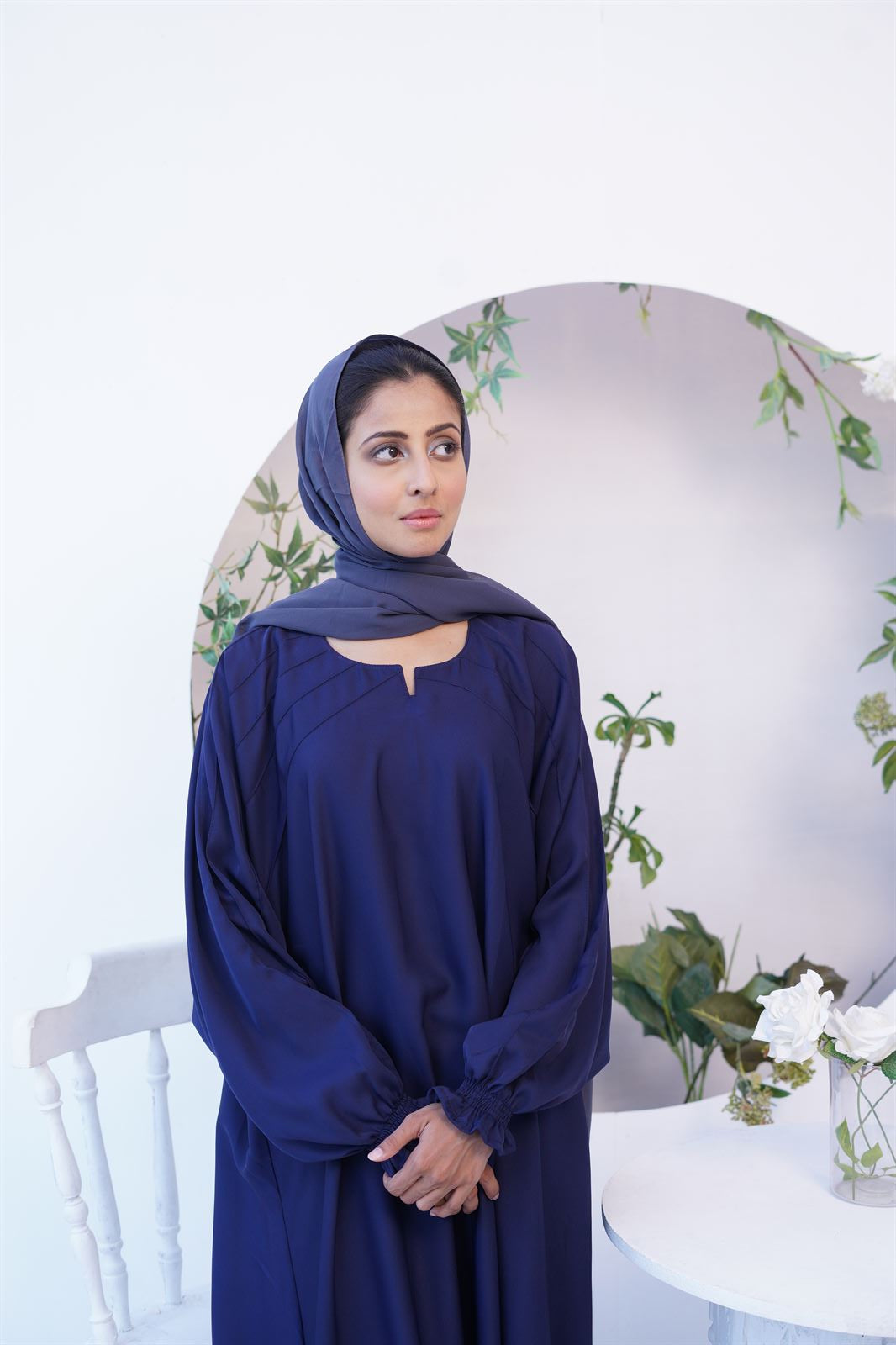 Closeup of girl wearing navy blue paintex kaftan maxi abaya burqa.