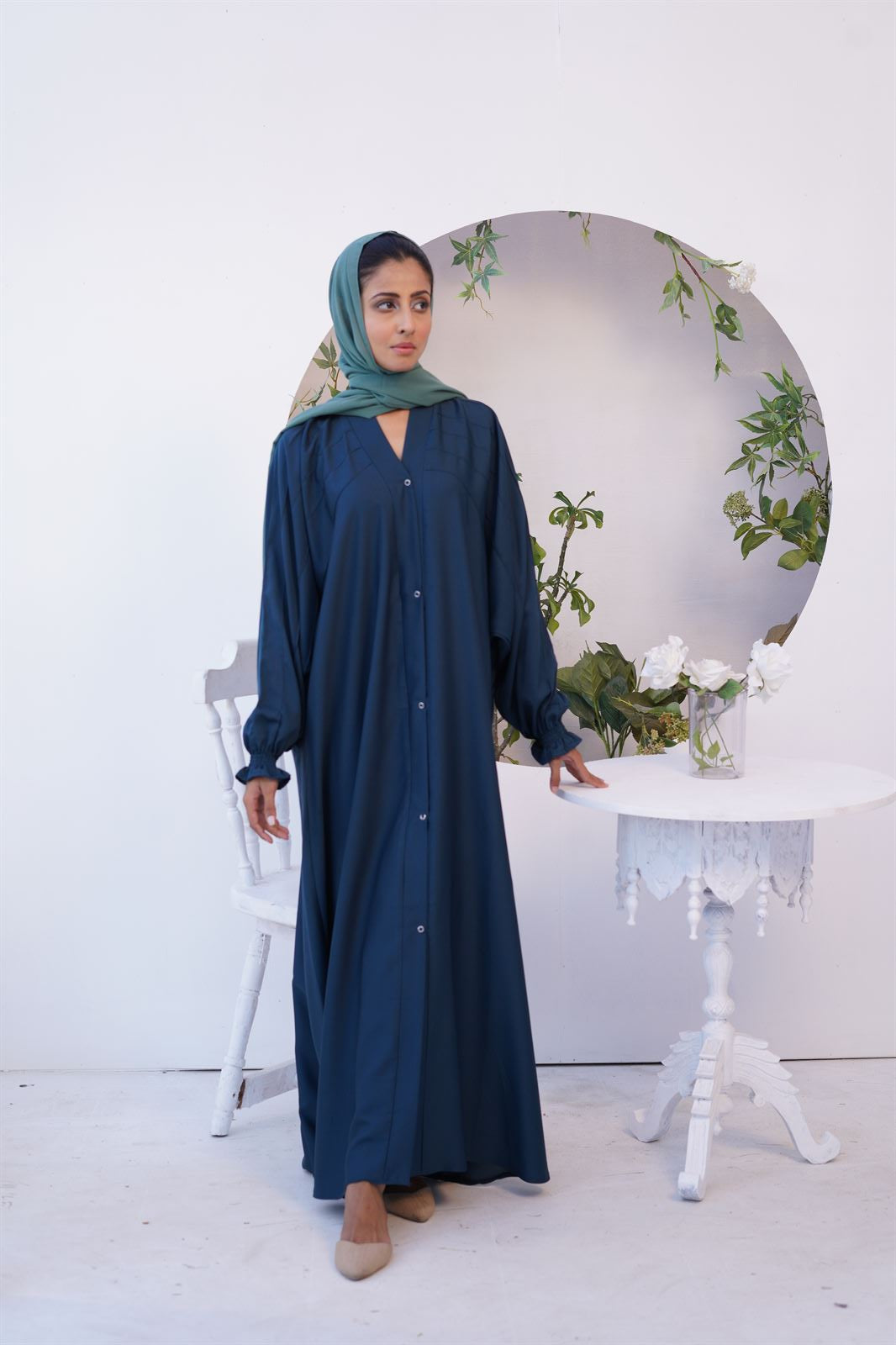 Girl Wearing Paintex Kaftan Gown Sea green Abaya standing in front of camera.