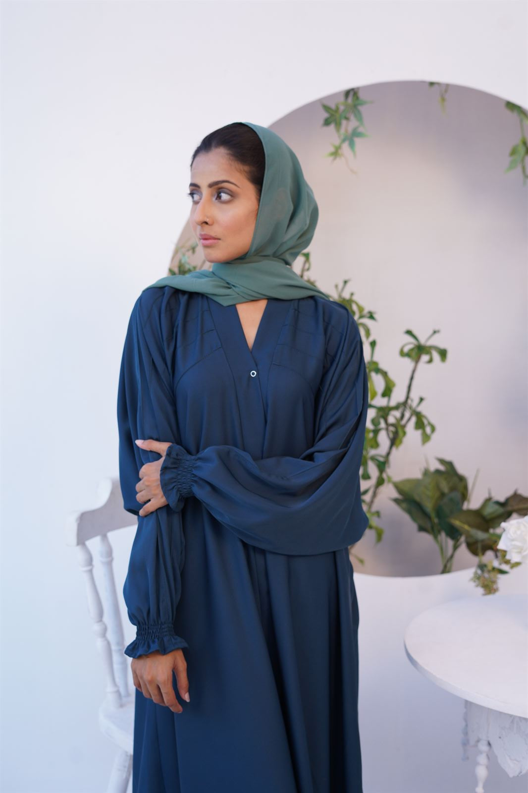 Girl Wearing Paintex Kaftan Gown Sea green Abaya standing looking right.