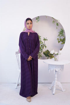 Girl Wearing Fancy style Zoom Emboss Gown Abaya in Dark Purple. Front view.