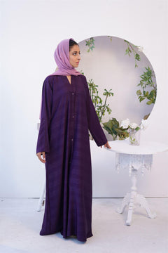 Girl Wearing Fancy style Zoom Emboss Gown Abaya in Dark Purple looking left.