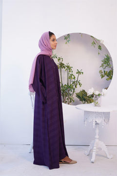 Girl Wearing Fancy style Zoom Emboss Gown Abaya in Dark Purple. side view.