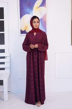 Buy Online abaya in pakistan. Girl wearing Zoom emboss gown abaya in mahogany.