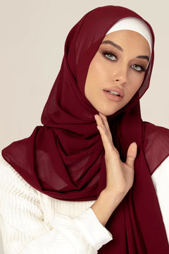  Georgette Hijab Online Pakistan in Maroon. Girl wearing over white top looking her straight.