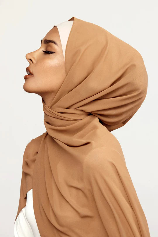 Georgette Hijab Online Pakistan, in cappuccino color . side profile of a woman wearing it with white top.