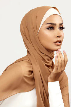 A women wearing Georgette Hijab, in Cappuccino colour, with white top, looking her left