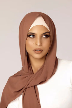 Georgette Hijab Online Pakistan, in mocha color . a women wearing it with white top looking her left.