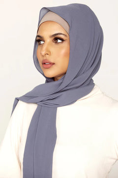 Georgette Hijab Online Pakistan, in denim gray color . a women wearing it with white top looking her right.