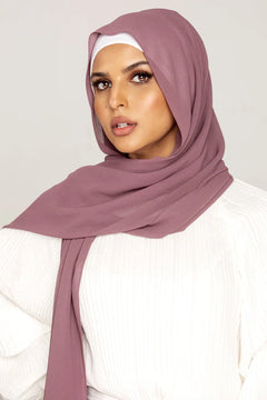 Georgette Hijab Online Pakistan, in dark mauve color . a women wearing it with white top looking her straight