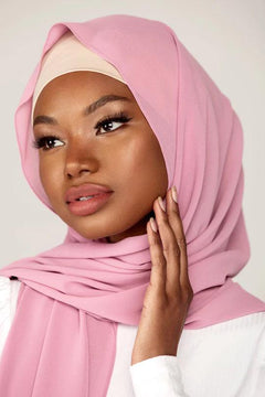 Georgette Hijab Online Pakistan, in French rose color. A woman wearing it with white top looking her straight.