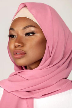 Georgette Hijab Online Pakistan, in blossom color. A woman wearing it with white top looking her right.