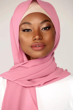 Georgette Hijab Online Pakistan, in blossom color. A woman wearing it with white top looking her STRAIGHT.