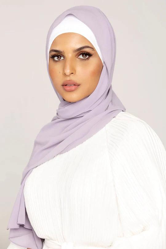 Georgette Hijab Online Pakistan, in preiwinkle color. A woman wearing it with white top looking her straight.