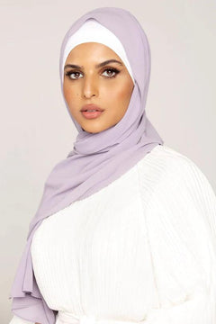 Georgette Hijab Online Pakistan, in preiwinkle color. A woman wearing it with white top looking her straight.