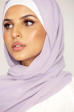 Georgette Hijab Online Pakistan, in preiwinkle color. A woman wearing it with white top looking her right.