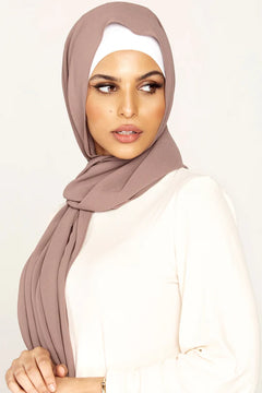 Georgette Hijab Online Pakistan, in taupe color . a women wearing it with white top looking her left.