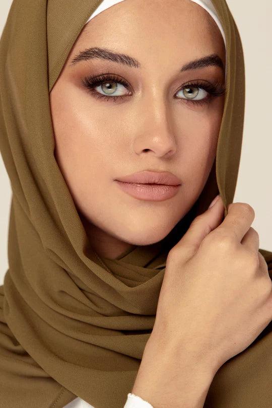 Georgette Hijab Online Pakistan, in tortilla color. A woman wearing it with white top looking her straight.