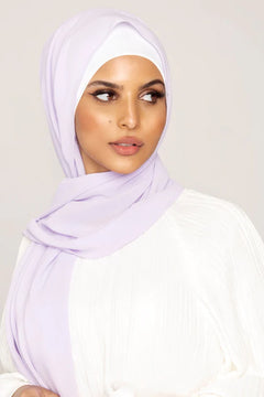 Georgette Hijab Online Pakistan, in lilac color. A woman wearing it with white top looking her left.