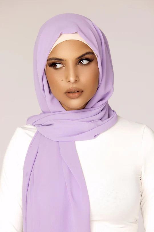 Georgette Hijab Online Pakistan, in lavender color . a women wearing it with white top looking her right