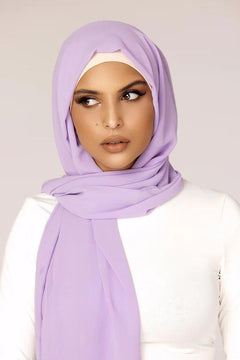 Georgette Hijab Online Pakistan, in lavender color . a women wearing it with white top looking her right