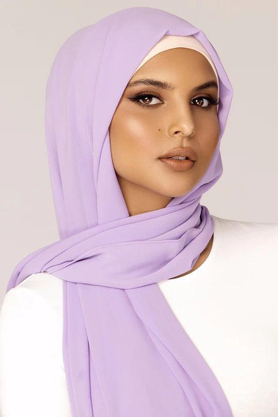 Georgette Hijab Online Pakistan, in lavender color . a women wearing it with white top looking straight.