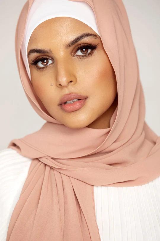 Georgette Hijab Online Pakistan, in blush color. A woman wearing it with white top looking her straight.