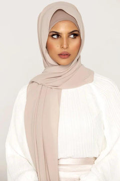 Georgette Hijab Online Pakistan, in milkshake color . a women wearing it with white top looking her left.