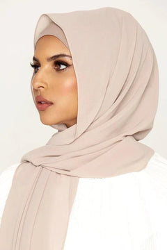 Georgette Hijab Online Pakistan, in milkshake color . a women wearing it with white top looking her right