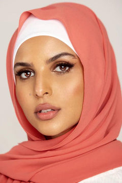 Georgette Hijab Online Pakistan, in flamingo color. A woman wearing it with white top looking her straight.