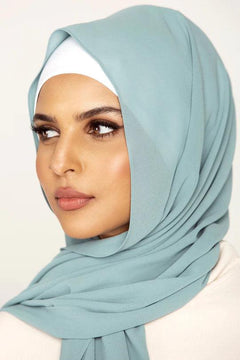 Georgette Hijab Online Pakistan, in Maldives color . a women wearing it with white top looking her right