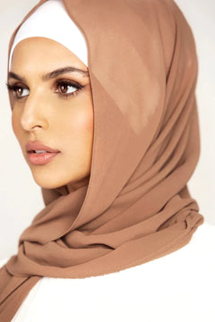 Georgette Hijab Online Pakistan, in espresso color . a women wearing it with white top looking her right.