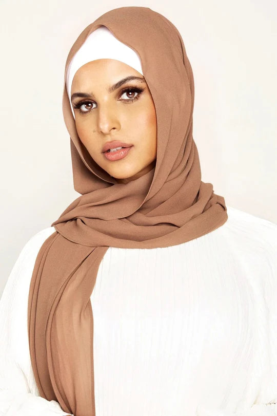 Georgette Hijab Online Pakistan, in espresso color . a women wearing it with white top looking her straight.