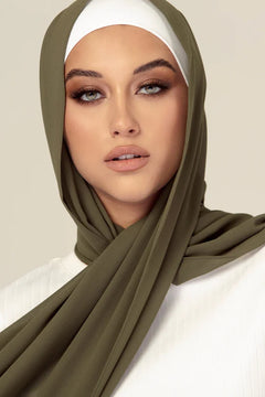 Georgette Hijab in sage. Girl styling over white top looking her straight.