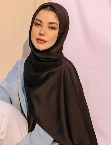 Stylish girl wearing satin silk hijab in black color.