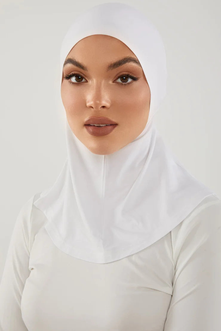 Girl wearing smooth neck cover hijab under cap in white color. Soft Stylish & easy to wear Neck Cover.