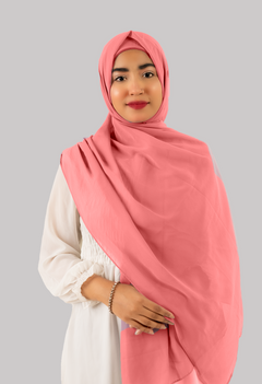 a women wearing instant hijab with cap in rose pink color georgette material front side. 
Luxurious georgette fabric with matching inner cap, a stylish and convenient solution for modest fashion.