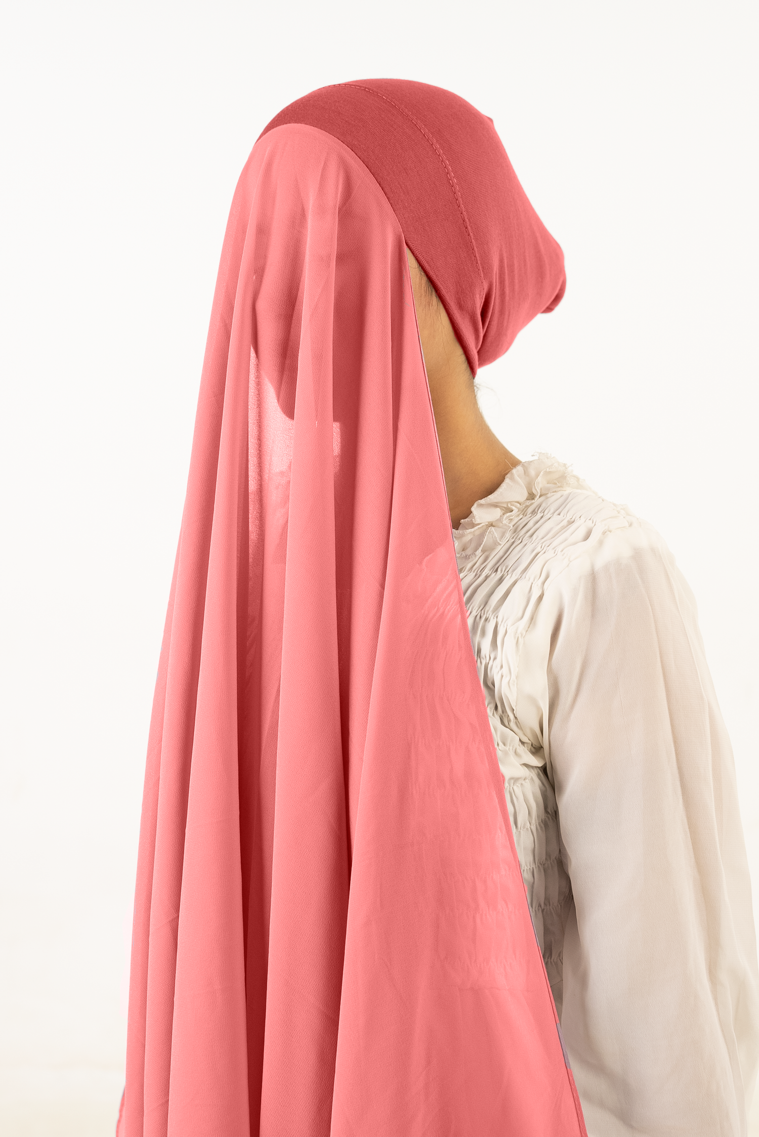 a women wearing instant hijab with cap in rose pink color georgette material side profile