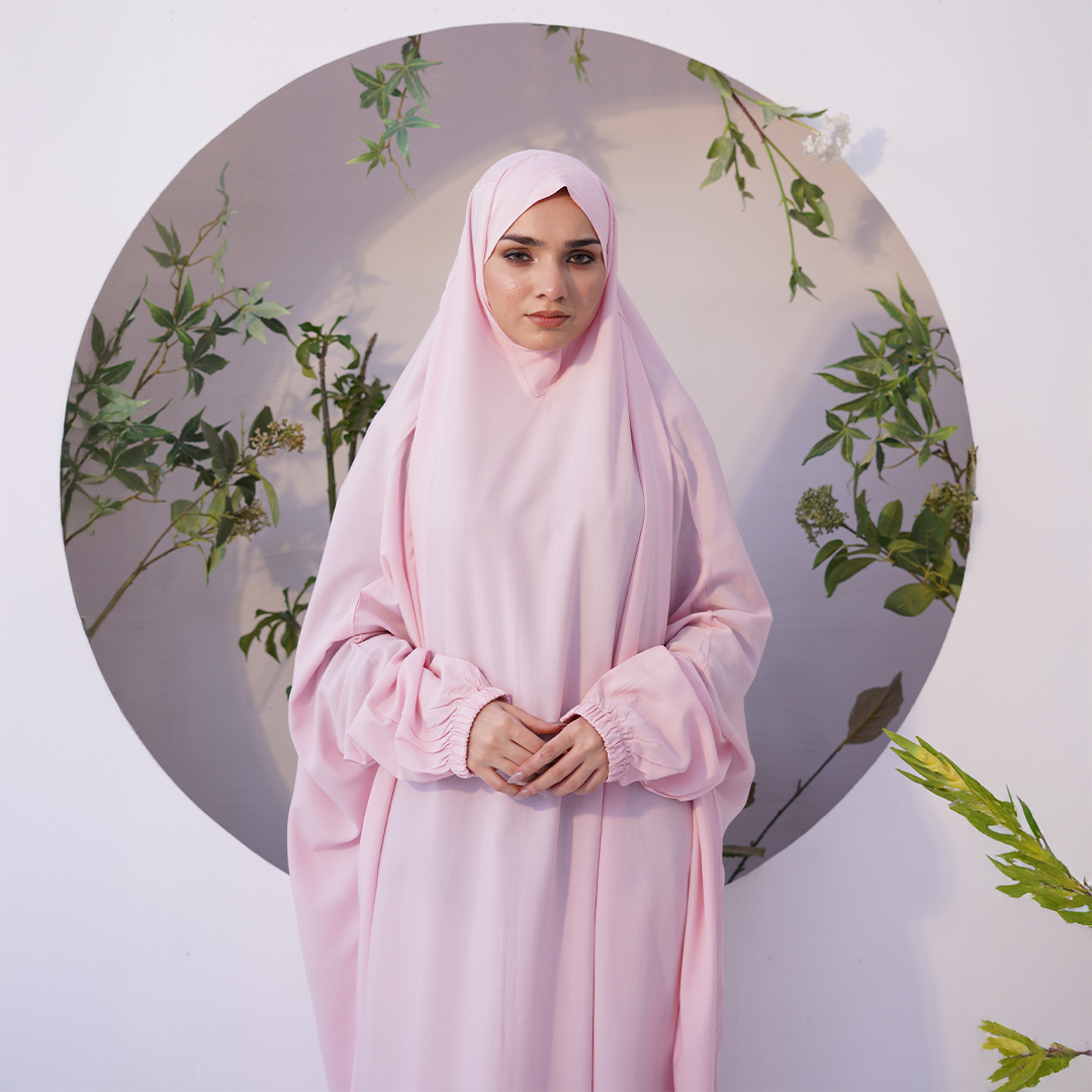 a girl wearing Namaz Chadar with sleeves Online Pakistan in baby pink color