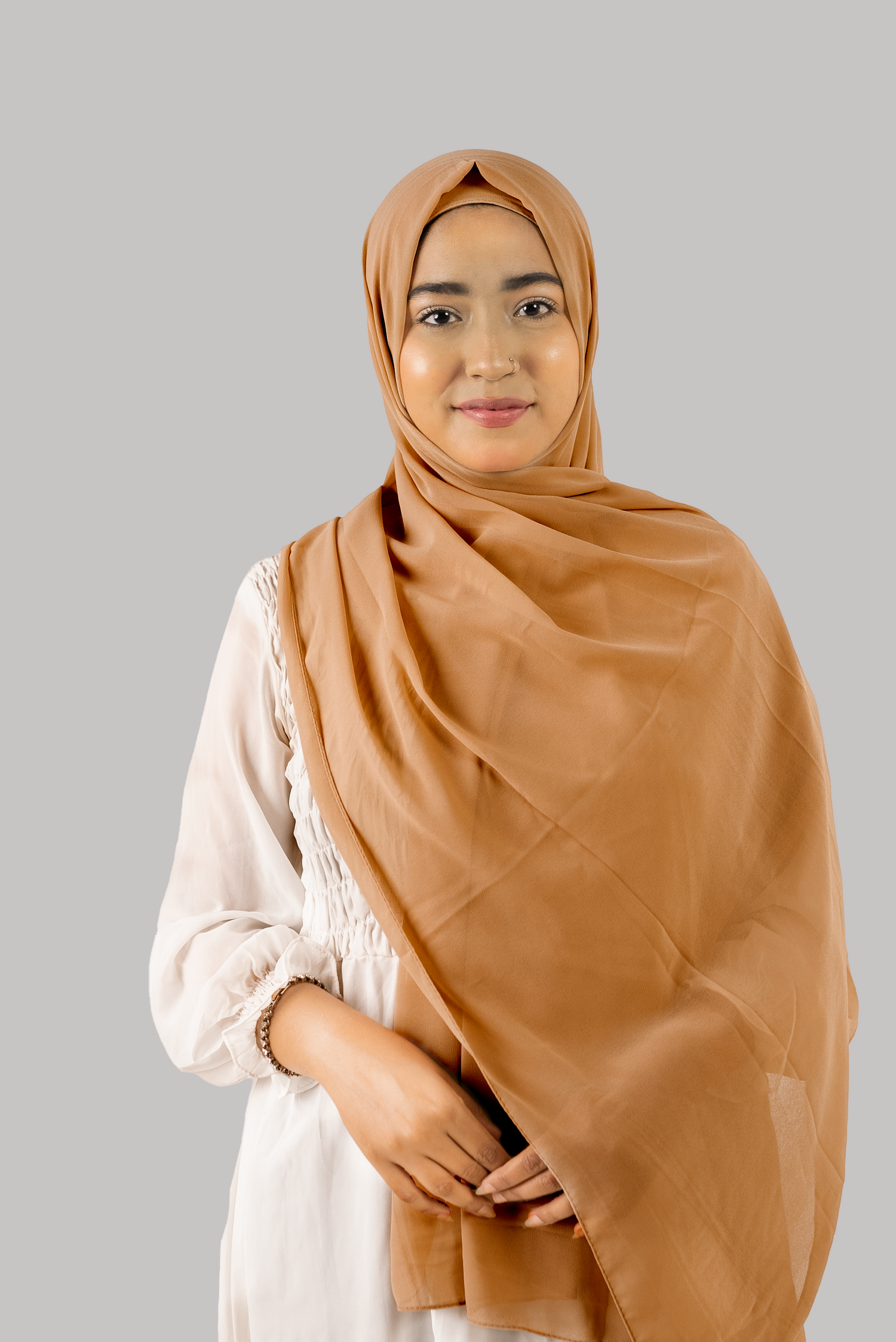 a women wearing instant hijab with cap in cedar color georgette material front side