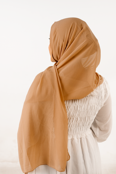 a women wearing instant hijab with cap cedar color georgette material back side